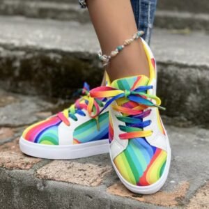 woman wearing colorful lace up sneakers and ankle bracelet