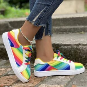 woman wearing colorful lace up sneakers and jeans on the grey stairs