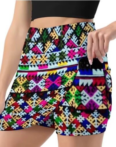 woman turned to her side wearing colorful mini skirt and taking a phone out of the pocket