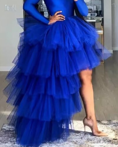 woman wearing colorful multi-layer skirt and beige heels