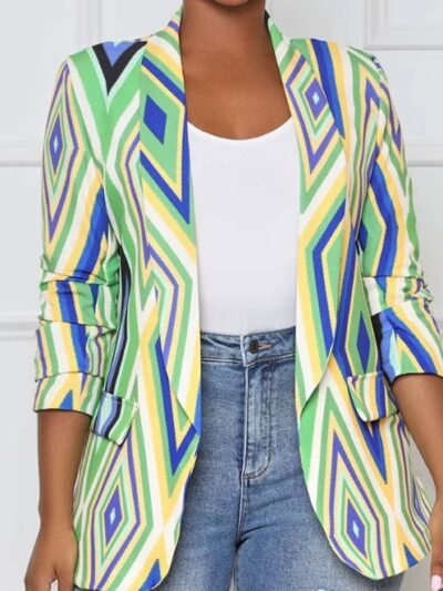 woman wearing colorful office blazer, white T-shirt and jeans, white room in the background