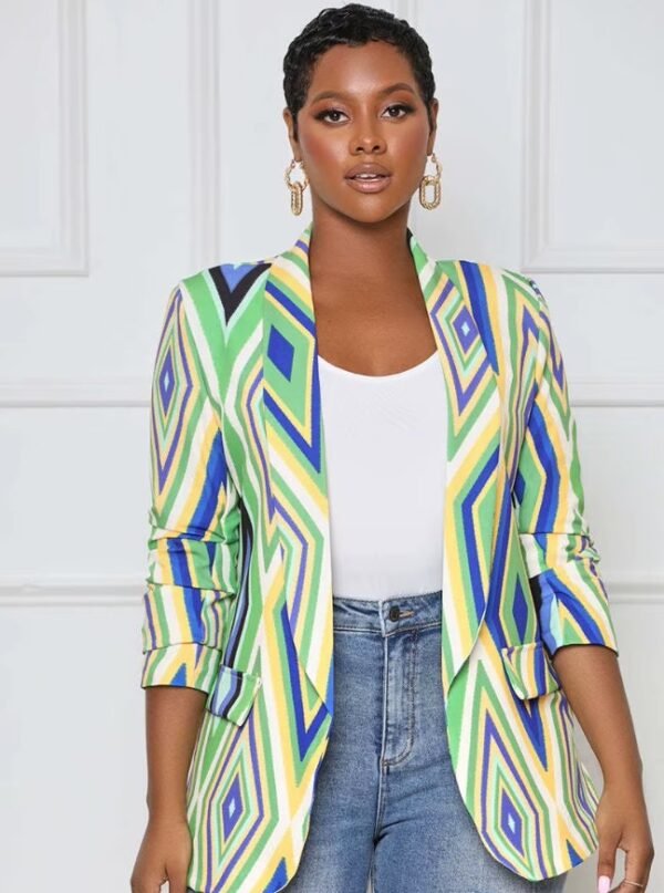 woman with short black hair wearing colorful office blazer, white top and jeans