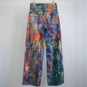 back view of colorful painted pants hanging on the grey backgorund