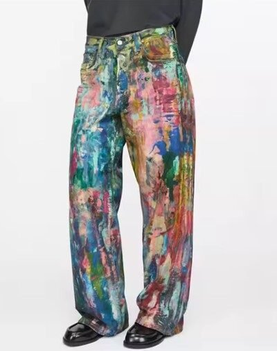 woman turned to her side wearing colorful painted pants, black shoes and black blouse