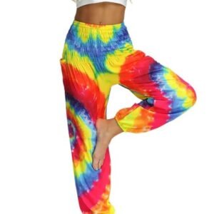 woman making yoga pose and wearing colorful palazzo pants