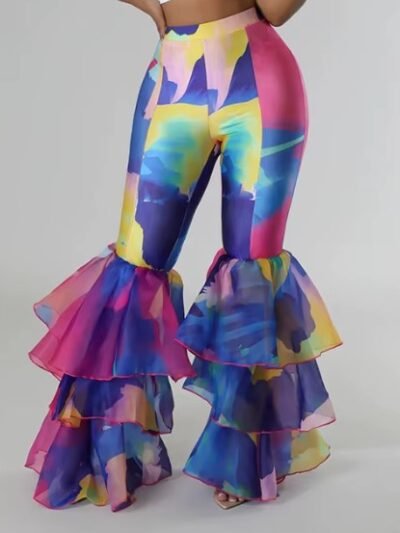 woman wearing colorful party pants, grey background