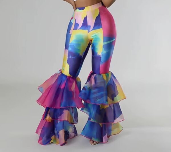 woman wearing colorful party pants, grey background