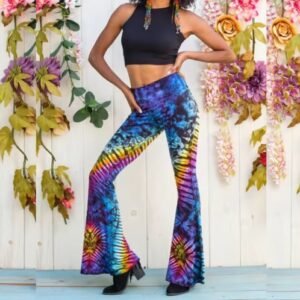 woman posing in colorful pattern pants and a black short-sleeved top