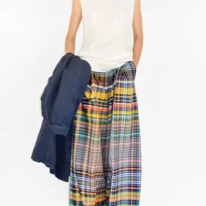 woman wearing colorful plaid pants and white top, white background