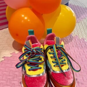 front view of colorful platform sneakers, colorful balloons behind them