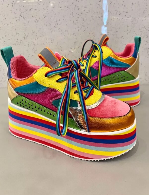 side view of colorful platform sneakers on a grey background