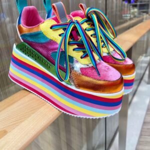 colorful platform sneakers standing on a wooden fence