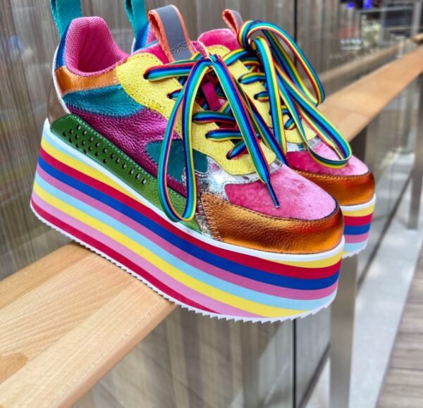 colorful platform sneakers standing on a wooden fence