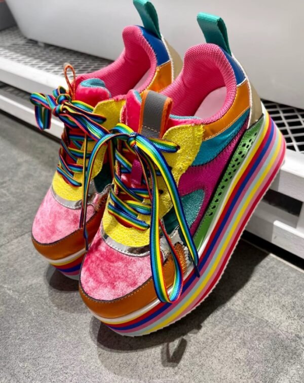 colorful platform sneakers lying on a grey ground