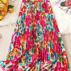 colorful pleated skirt on a carpet, yellow flowers and a newspaper next to it