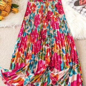 back view of colorful pleated skirt on a beige carpet, yelow flowers next to it