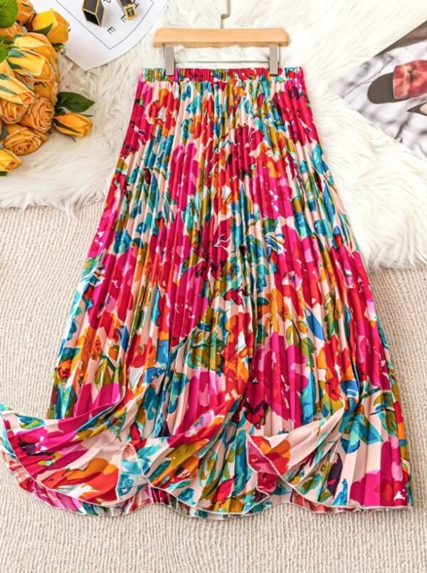 back view of colorful pleated skirt on a beige carpet, yelow flowers next to it