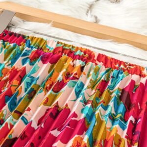 waistline of colorful pleated skirt on a brown hanger