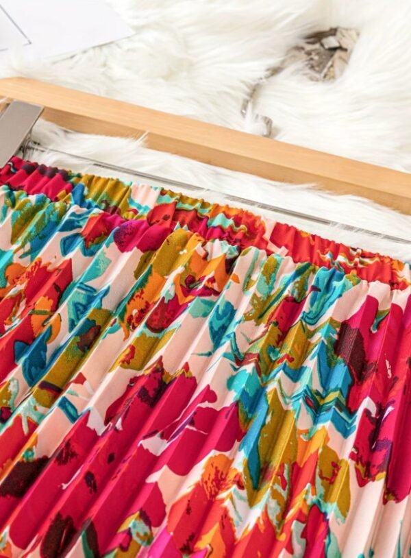 waistline of colorful pleated skirt on a brown hanger