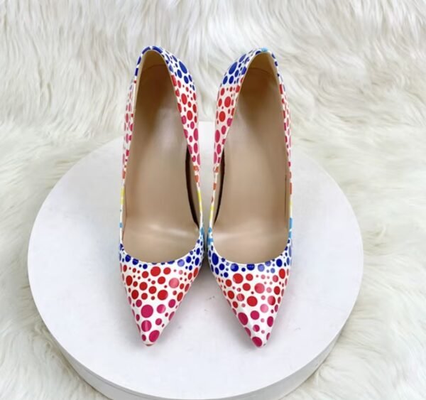 front view of colorful polka dots heels on the white stool