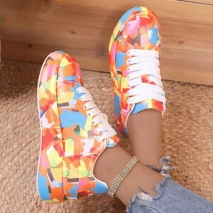 woman wearing colorful print sneakers and a shiny ankle bracelet