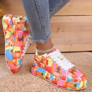 woman turned to her side wearing colorful print sneakers and jeans