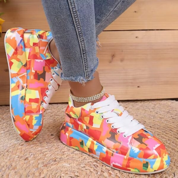 woman turned to her side wearing colorful print sneakers and jeans