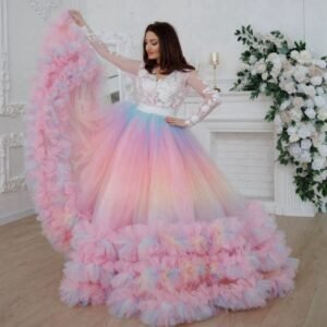 woman wearing colorful prom skirt and elegant white top, white room and flowers behind her