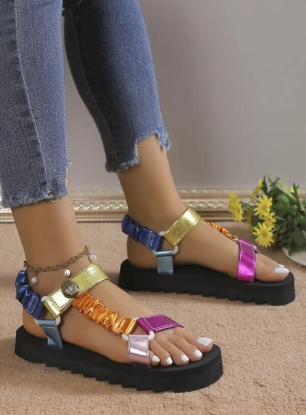 woman turned to her side wearing colorful sandals for women and jeans