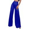 woman wearing royal blue colorful sequin pants, white background