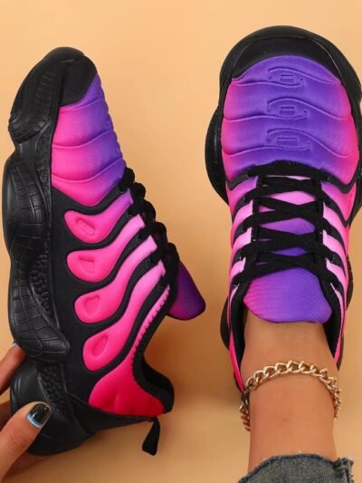 woman wearing one of colorful sneakers for ladies and holding the other one, exposing its side view