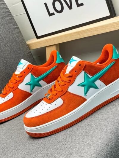 colorful sneakers with stars lying on a grey sofa, a white poster behind them