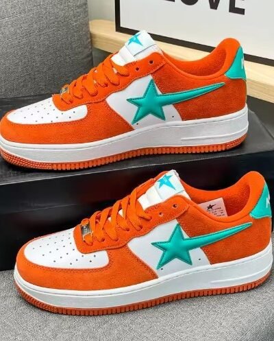 colorful sneakers with stars on a grey carpet, one of them is elevated on a black box