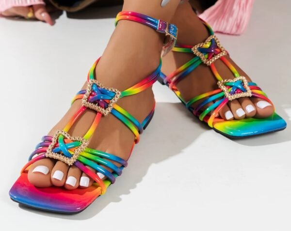 woman wearing colorful square sandals and crossing her legs