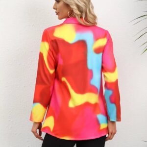 woman turned to her back wearing colorful tie-dye blazer, grey wall in the background