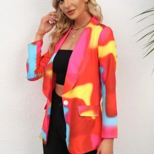 woman wearing colorful tie-dye blazer, black pants and a black top, she is smiling