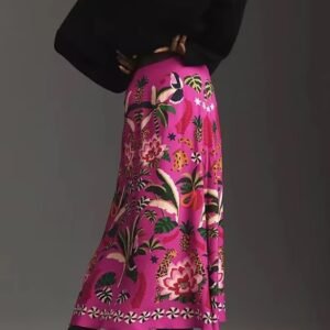 woman turned to her back wearing colorful tropical skirt, black hoodie and black boots