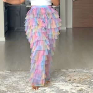 woman wearing colorful tulle pants, grey room in the backgorund