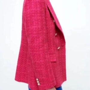 woman turned to her side wearing pink colorful tweed blazer