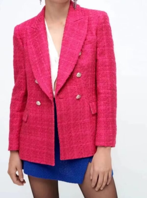 woman wearing pink colorful tweed blazer and blue shorts