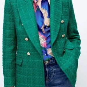 woman wearing green colorful tweed blazer over a blue blouse and jeans