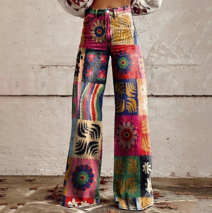 woman wearing colorful vintage pants, grey wall in the background