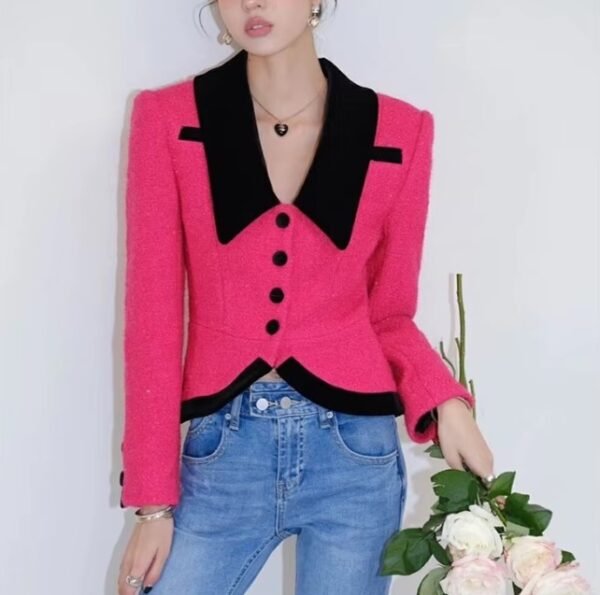 woman wearing elegant colorful blazer and jeans, she is holding a bouquet of white roses