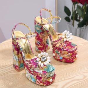 fancy colorful heels on a wooden table, red roses in the background