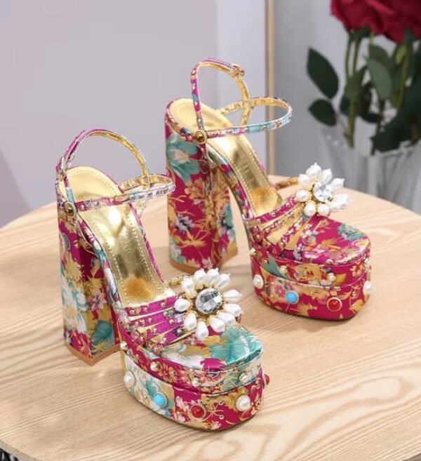 fancy colorful heels on a wooden table, red roses in the background