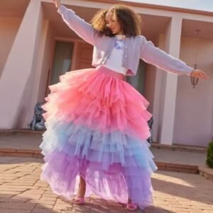 woman wearing fancy colorful skirt and a grey hoodie, she is dancing happily