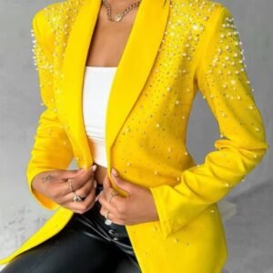 woman wearing female yellow blazer, white top and black pants, grey background