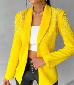 woman wearing female yellow blazer and a white top under it, she is holding the blazer's material