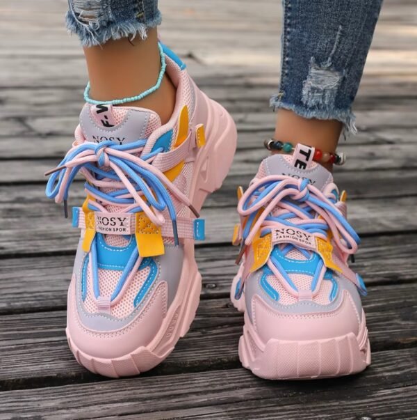 woman walking in girly colorful sneakers on a grey wood