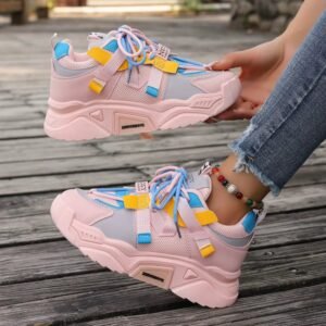 woman wearing girly colorful sneakers and holding them